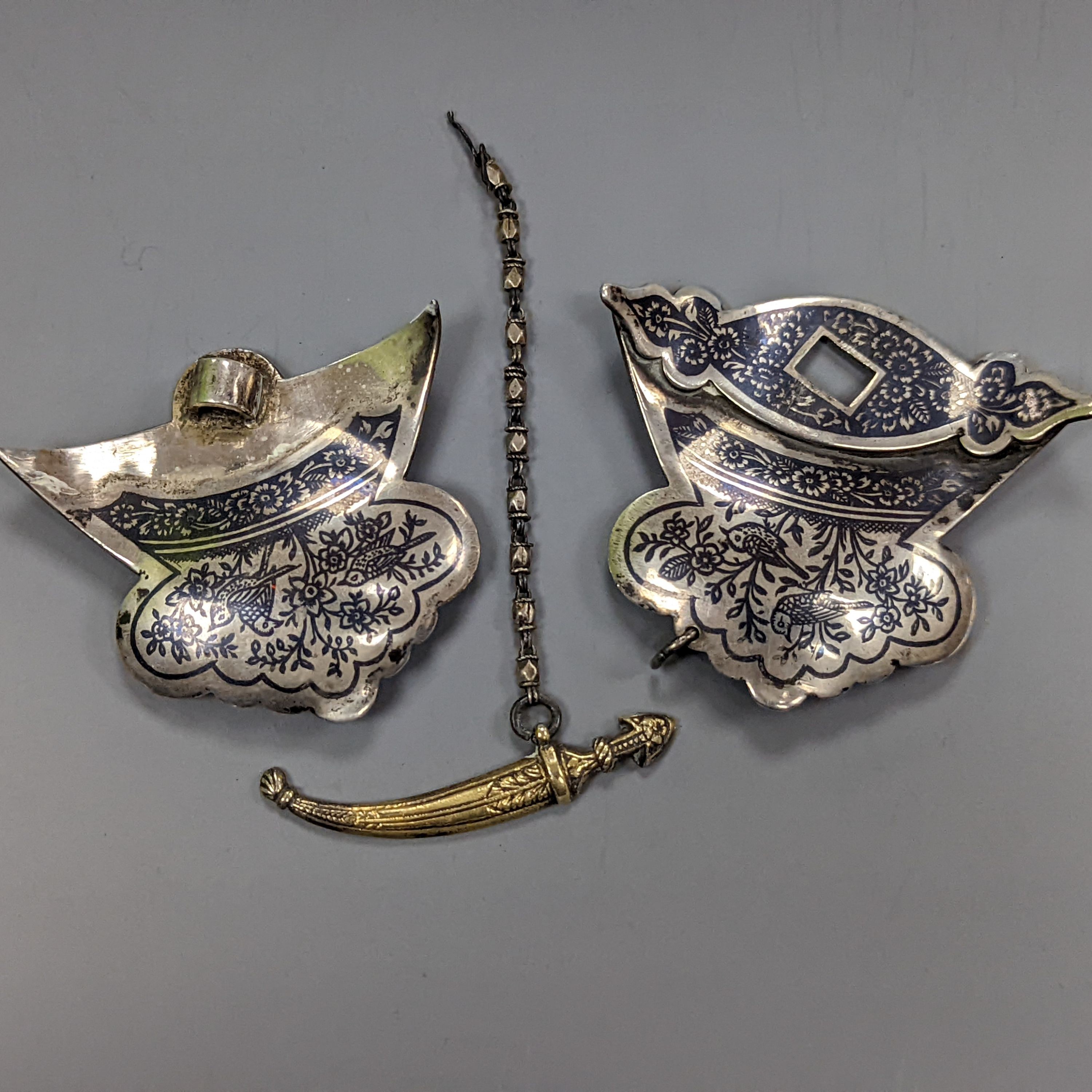 A 19th century Persian white metal and niello belt buckle, 9cm. wide